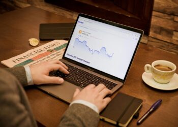 a person typing on a laptop on a table