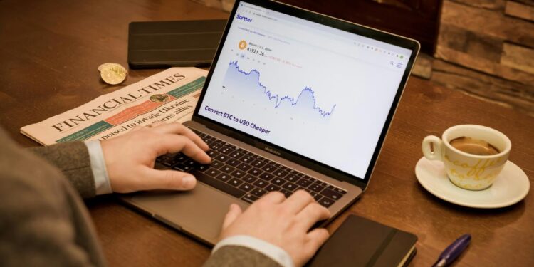 a person typing on a laptop on a table